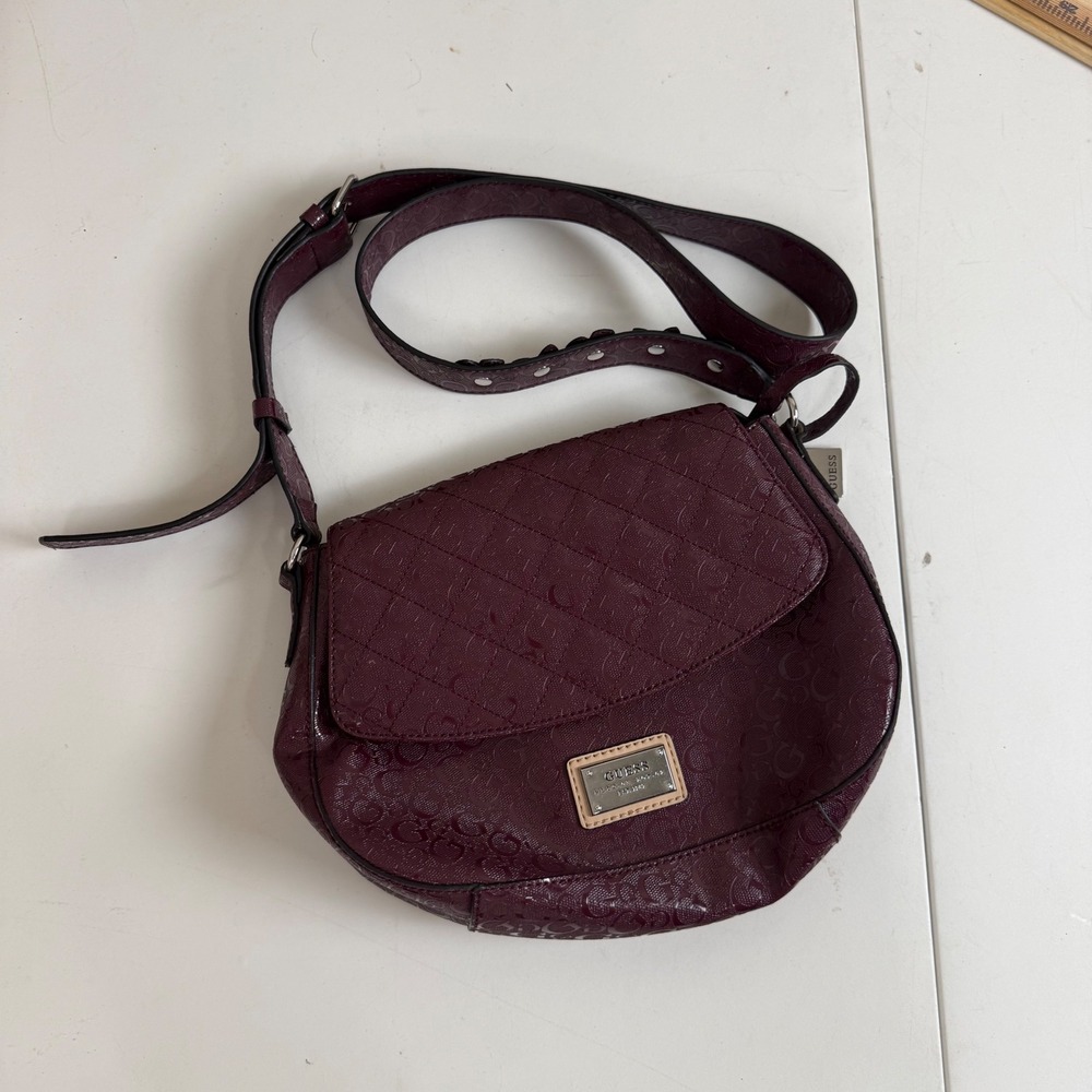 GUESS Burgundy Monogram Embossed Crossbody Saddle Bag Silver Studded Strap